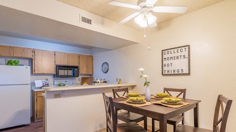 Ridgepointe dining are with ceiling fan and nice lighting